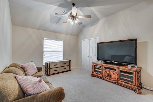 living room with lofted ceiling, visible vents, a ceiling fan, and light colored carpet