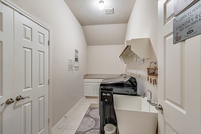 laundry area featuring washer and dryer, a sink, baseboards, and light tile patterned floors