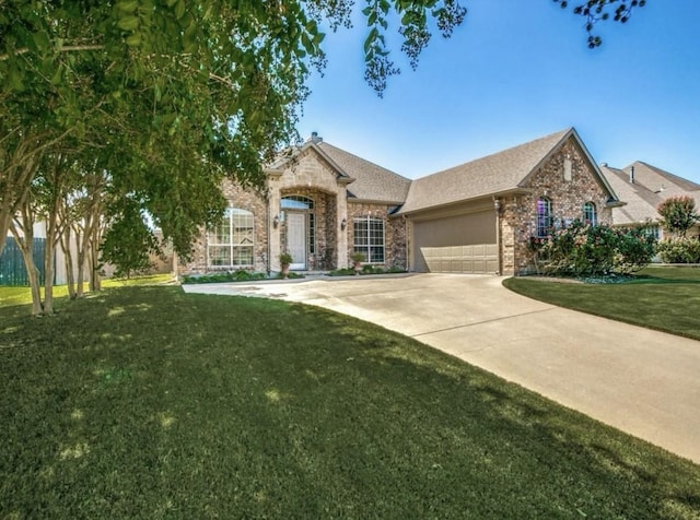 view of front of property featuring concrete driveway, a front lawn, an attached garage, and brick siding