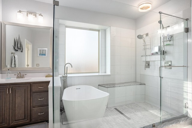 full bathroom featuring a soaking tub, a shower stall, and vanity