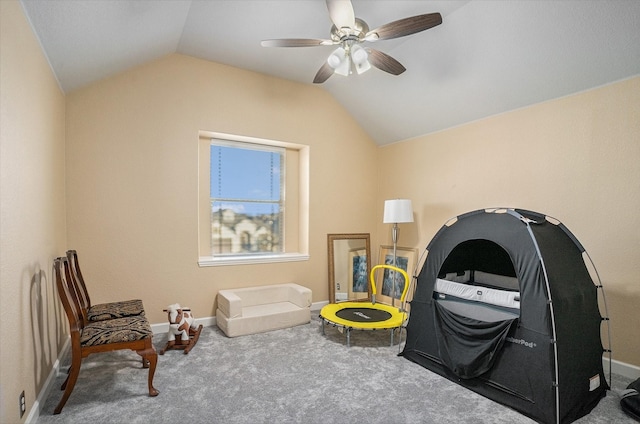 living area featuring vaulted ceiling, carpet, and baseboards