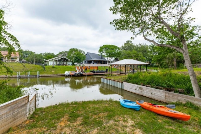 dock area with a water view and a lawn