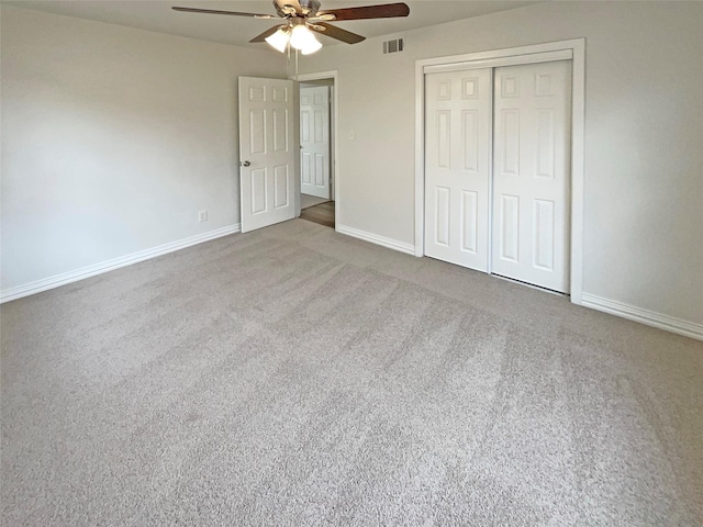 unfurnished bedroom with carpet, baseboards, visible vents, and a closet