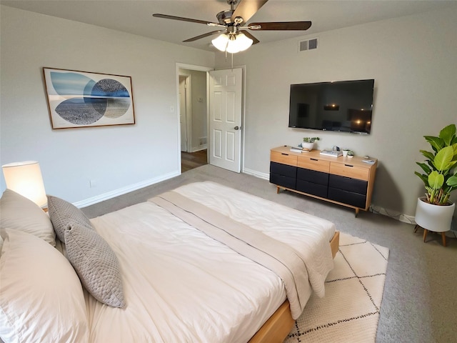 carpeted bedroom featuring baseboards, visible vents, and ceiling fan