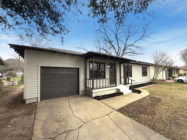 view of front of house with a garage, driveway, and a porch