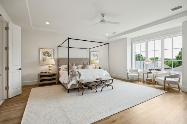 9514 Still Creek Ln, Dallas, TX 75238 - bedroom with baseboards, wood finished floors, a tray ceiling, recessed lighting, and a ceiling fan