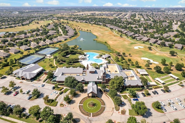 birds eye view of property with view of golf course, a water view, and a residential view