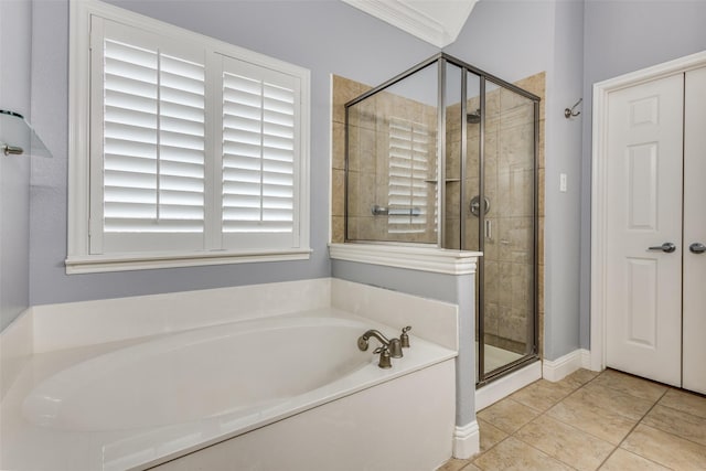 bathroom with ornamental molding, a shower stall, a bath, and tile patterned floors