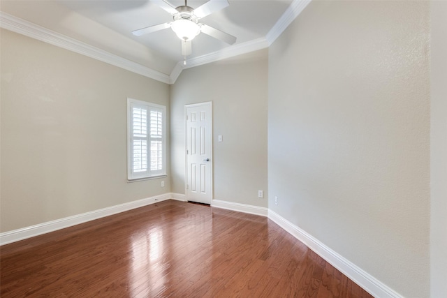 spare room featuring a ceiling fan, crown molding, baseboards, and wood finished floors