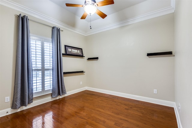 empty room with a healthy amount of sunlight, ceiling fan, baseboards, and wood finished floors