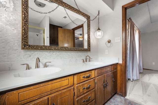 bathroom featuring double vanity, a shower, a sink, and visible vents