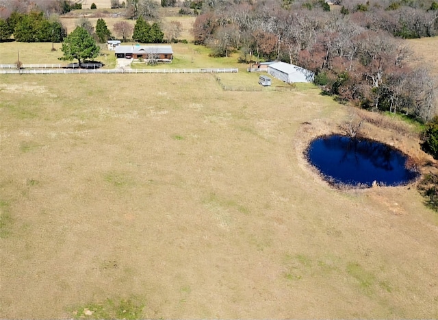 birds eye view of property with a water view and a rural view