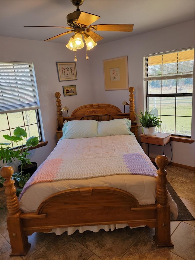 bedroom with ceiling fan and tile patterned floors