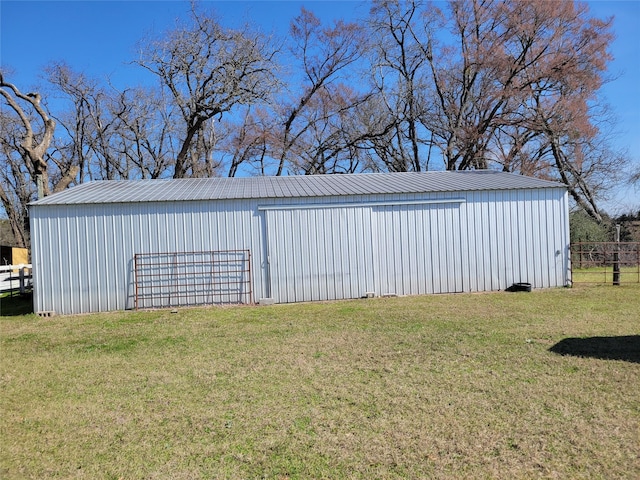 view of yard featuring an outbuilding, a detached garage, and an outdoor structure