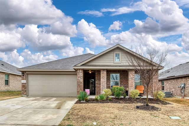 view of front of home featuring driveway, brick siding, an attached garage, and central air condition unit