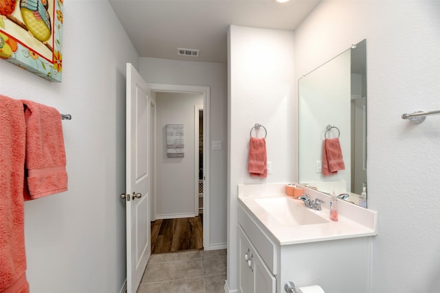 bathroom with tile patterned flooring, visible vents, and vanity