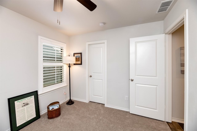 bedroom with light carpet, baseboards, visible vents, and ceiling fan