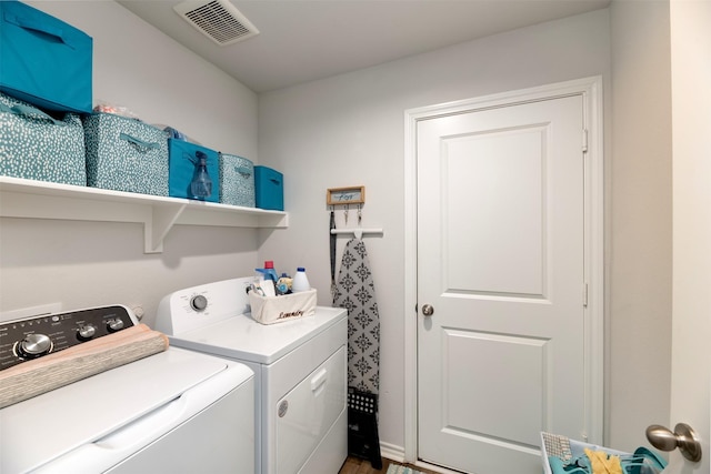 clothes washing area with laundry area, washer and clothes dryer, and visible vents