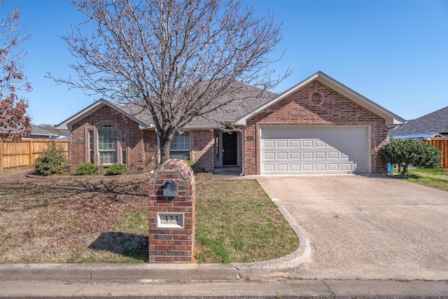 single story home with driveway, a garage, fence, and brick siding