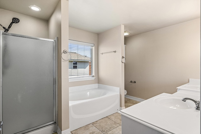 full bathroom featuring a garden tub, toilet, a shower stall, vanity, and tile patterned flooring