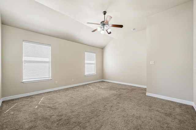 unfurnished room with a ceiling fan, carpet flooring, vaulted ceiling, and baseboards