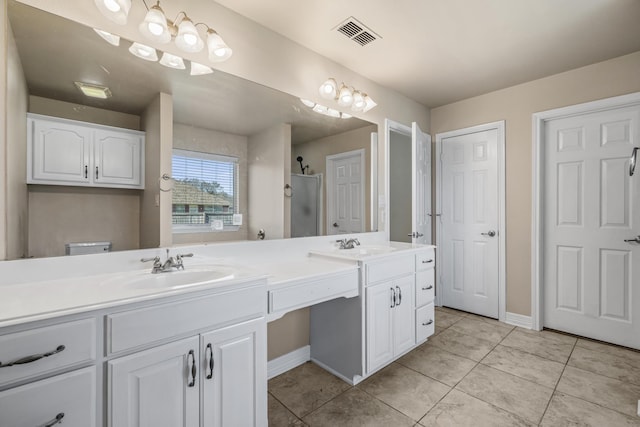 full bath featuring double vanity, a stall shower, visible vents, and a sink