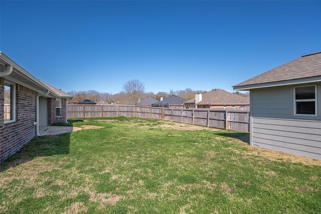 view of yard with a fenced backyard