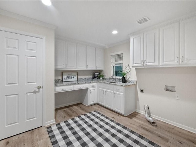 5114 Westhaven Rd, Arlington, TX 76017 - laundry area featuring cabinet space, electric dryer hookup, light wood finished floors, recessed lighting, and ornamental molding