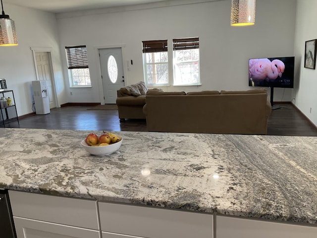 living room featuring dark wood-type flooring and baseboards