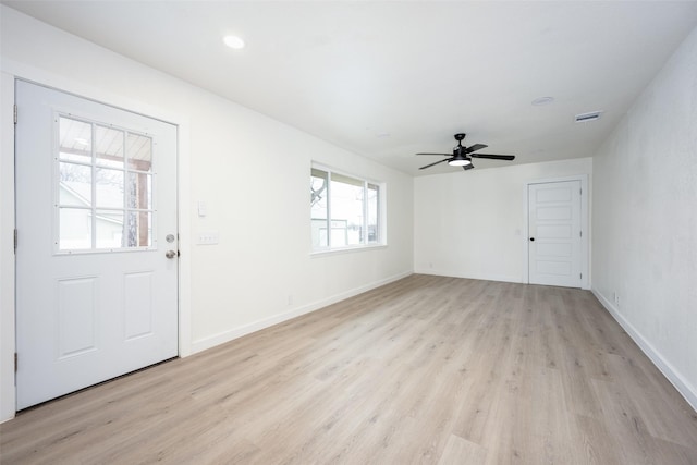 foyer featuring ceiling fan, light wood-style flooring, visible vents, and baseboards