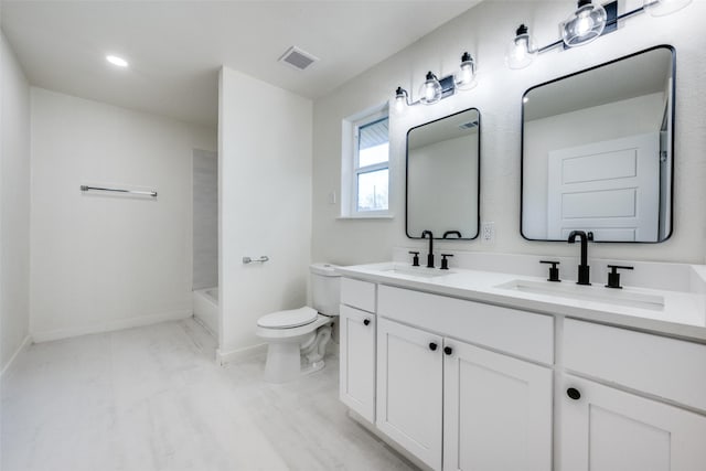 full bathroom with visible vents, a sink, toilet, and double vanity