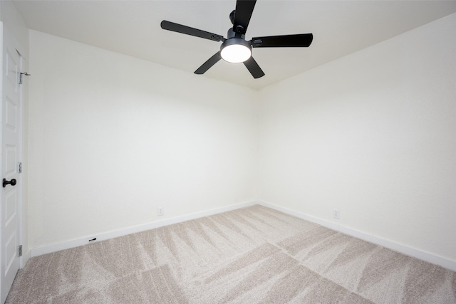 carpeted spare room with baseboards