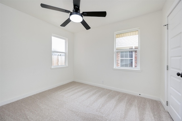 spare room featuring carpet floors, ceiling fan, and baseboards