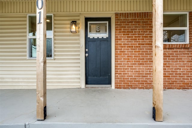 property entrance with brick siding