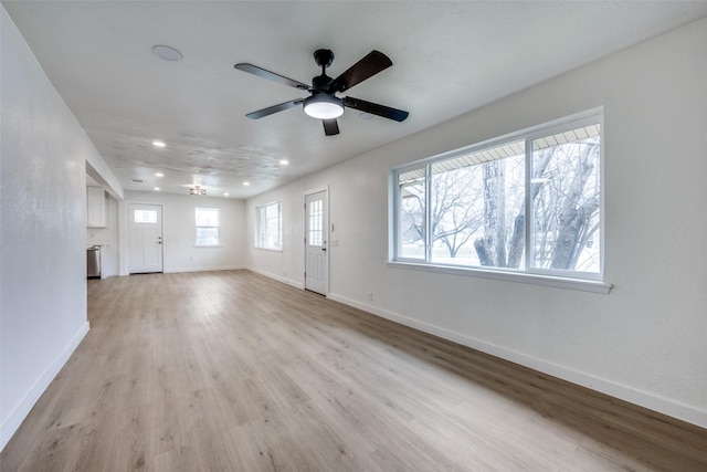 unfurnished living room featuring light wood-style flooring, baseboards, a ceiling fan, and recessed lighting