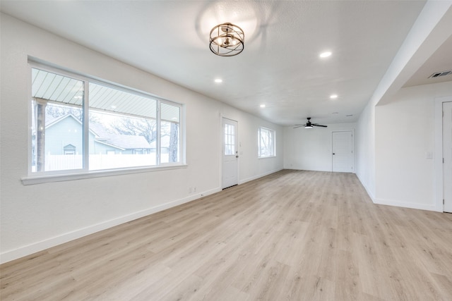 interior space featuring recessed lighting, baseboards, visible vents, and light wood finished floors