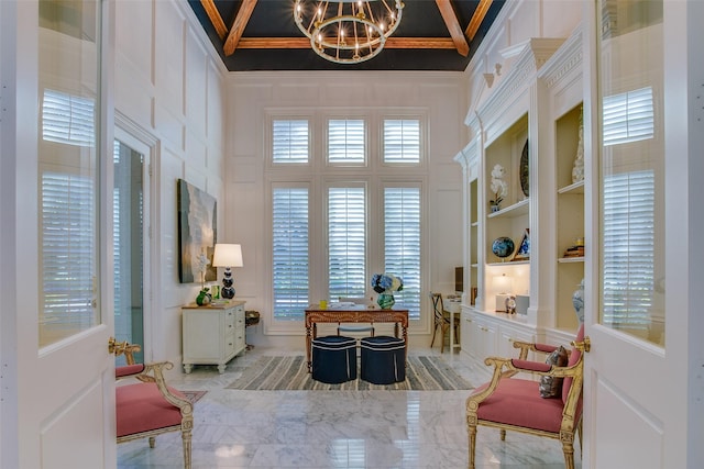 sitting room with ornamental molding and a notable chandelier