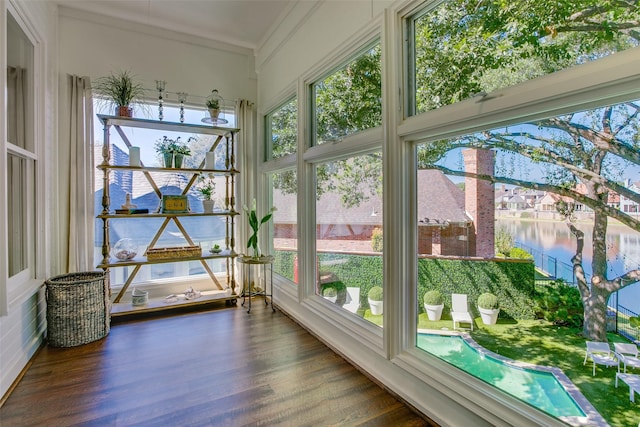 unfurnished sunroom featuring a water view