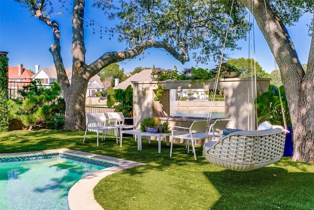 pool featuring fence and a lawn