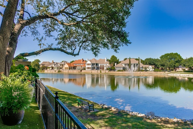 property view of water featuring a residential view and fence