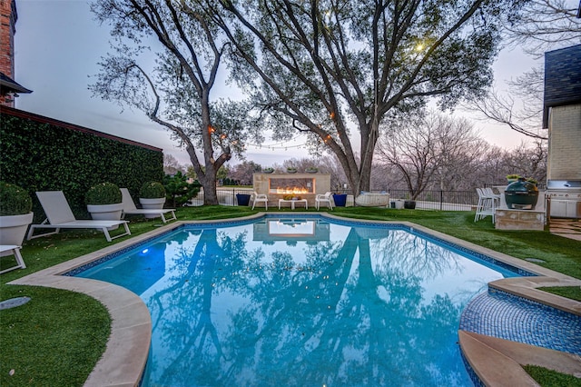 view of swimming pool with a fenced in pool, a fenced backyard, a yard, and grilling area