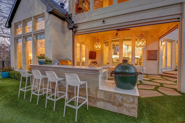 view of patio / terrace featuring exterior kitchen, outdoor dry bar, and area for grilling