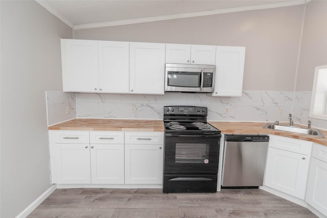 kitchen with stainless steel appliances, white cabinets, and a sink