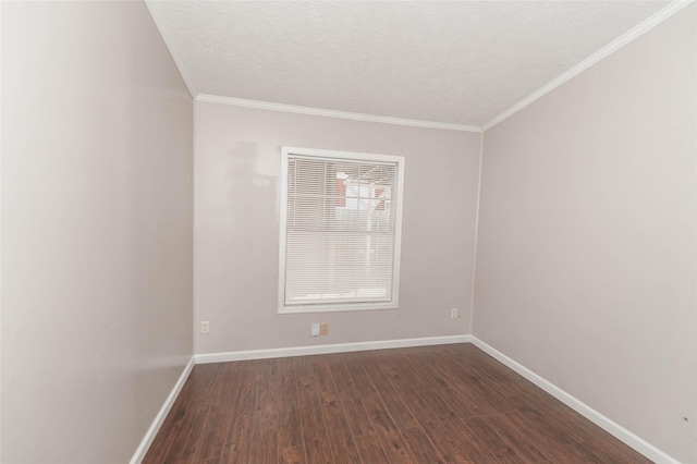 spare room with dark wood-style floors, ornamental molding, a textured ceiling, and baseboards