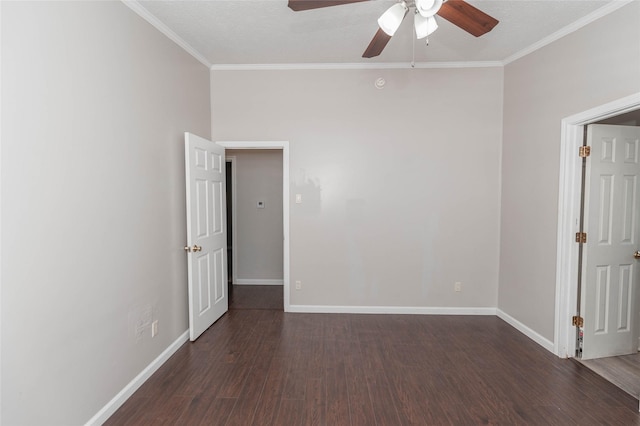 unfurnished room with ornamental molding, dark wood finished floors, and baseboards