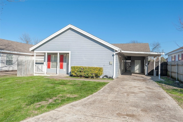 view of front facade featuring an attached carport, a porch, fence, concrete driveway, and a front yard