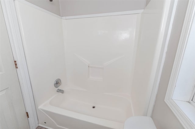 full bathroom with tub / shower combination and toilet