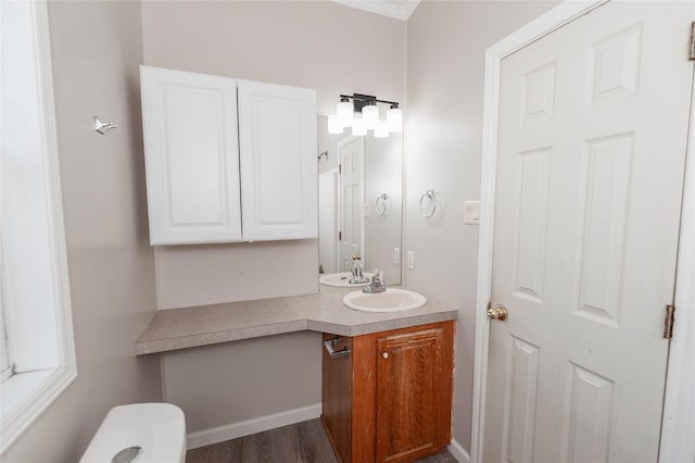 half bathroom with wood finished floors and vanity