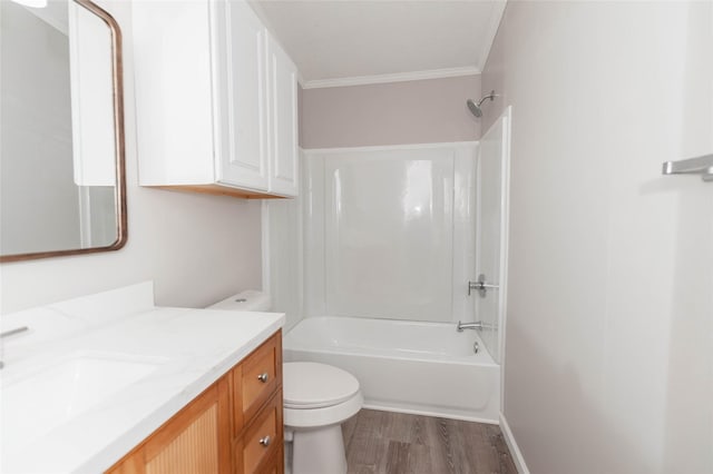 bathroom featuring toilet, vanity, wood finished floors, crown molding, and shower / bathtub combination