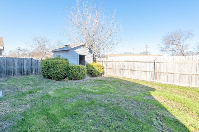 view of yard featuring an outbuilding and a fenced backyard